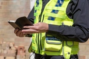 Police officer writing in notebook